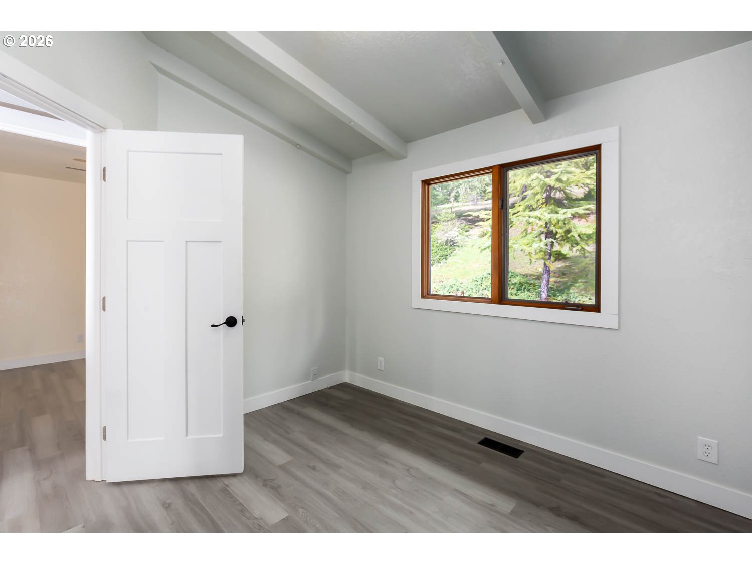 48187 McFarland Road Oakridge, OR 97463 - Photo 30 of 41 a view of an empty room with wooden floor and a window