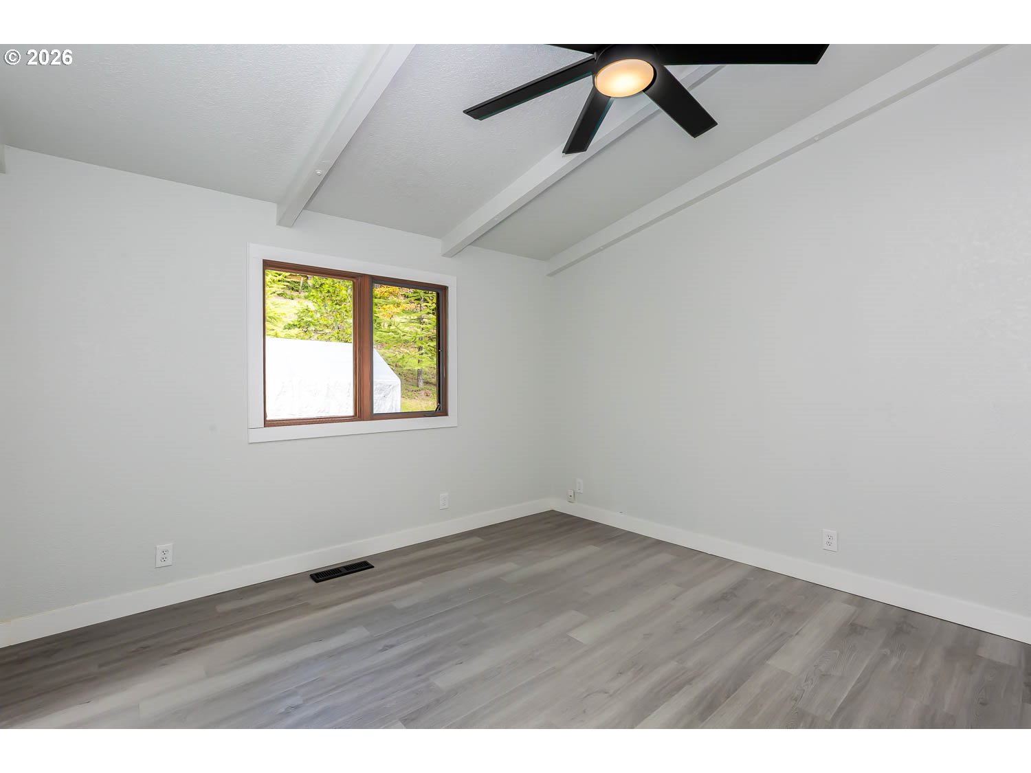 48187 McFarland Road Oakridge, OR 97463 - Photo 33 of 41 an empty room with wooden floor and windows