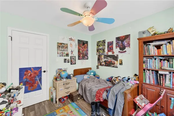 a bedroom with furniture and a book shelf