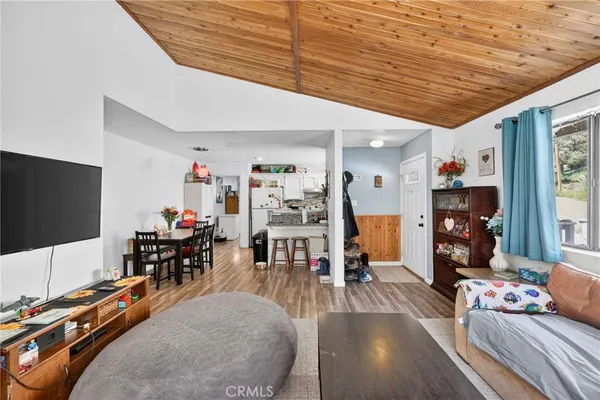 a view of a livingroom with furniture and a flat screen tv