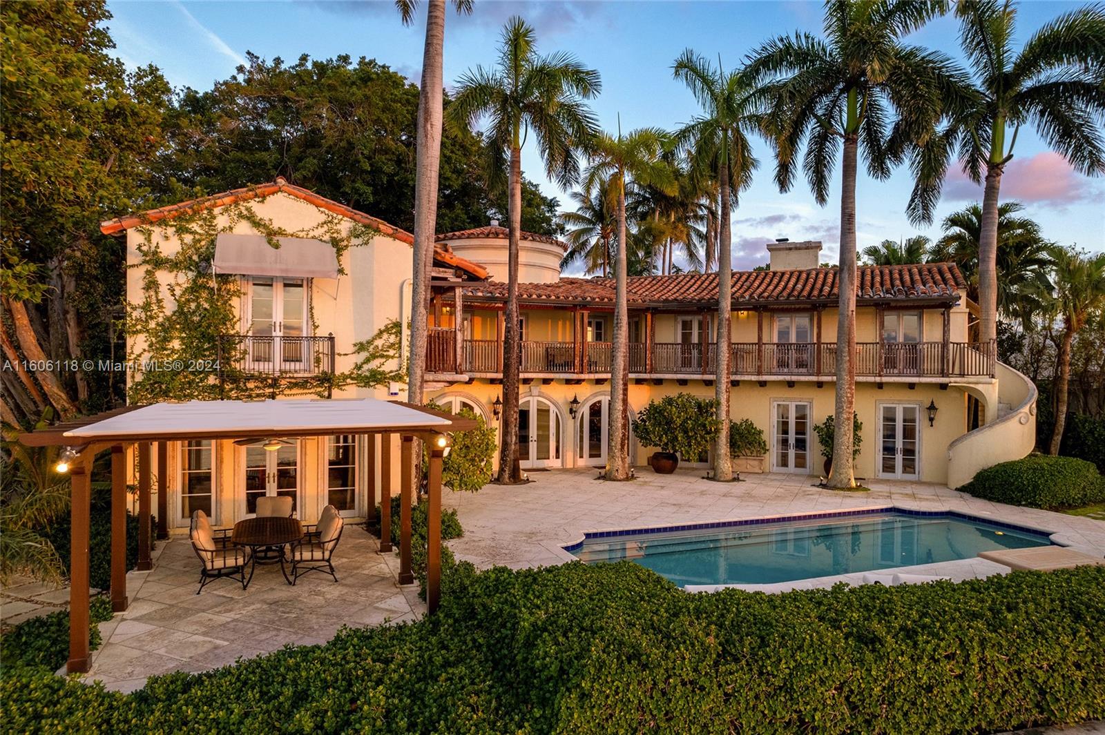4810 North Bay Road Miami Beach, FL 33140 - Photo 15 of 61 a view of a house with a swimming pool and sitting area