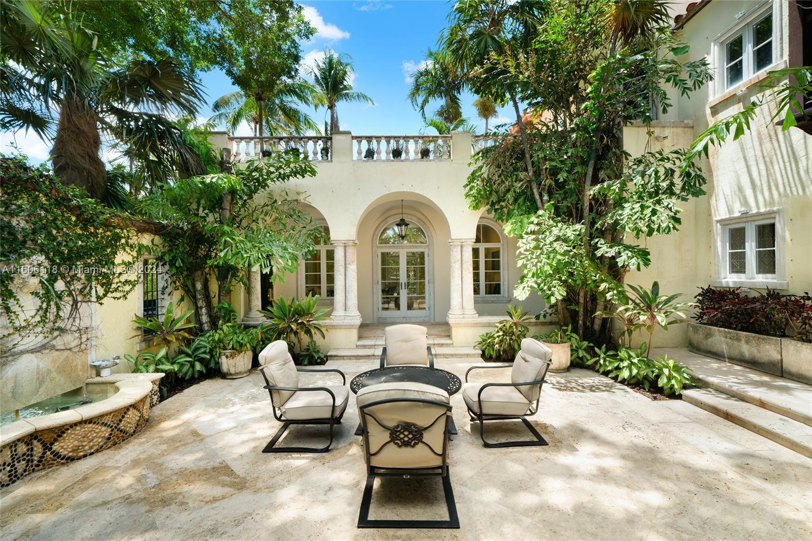 4810 North Bay Road Miami Beach, FL 33140 - Photo 16 of 61 a view of a patio with couches table and chairs and potted plants