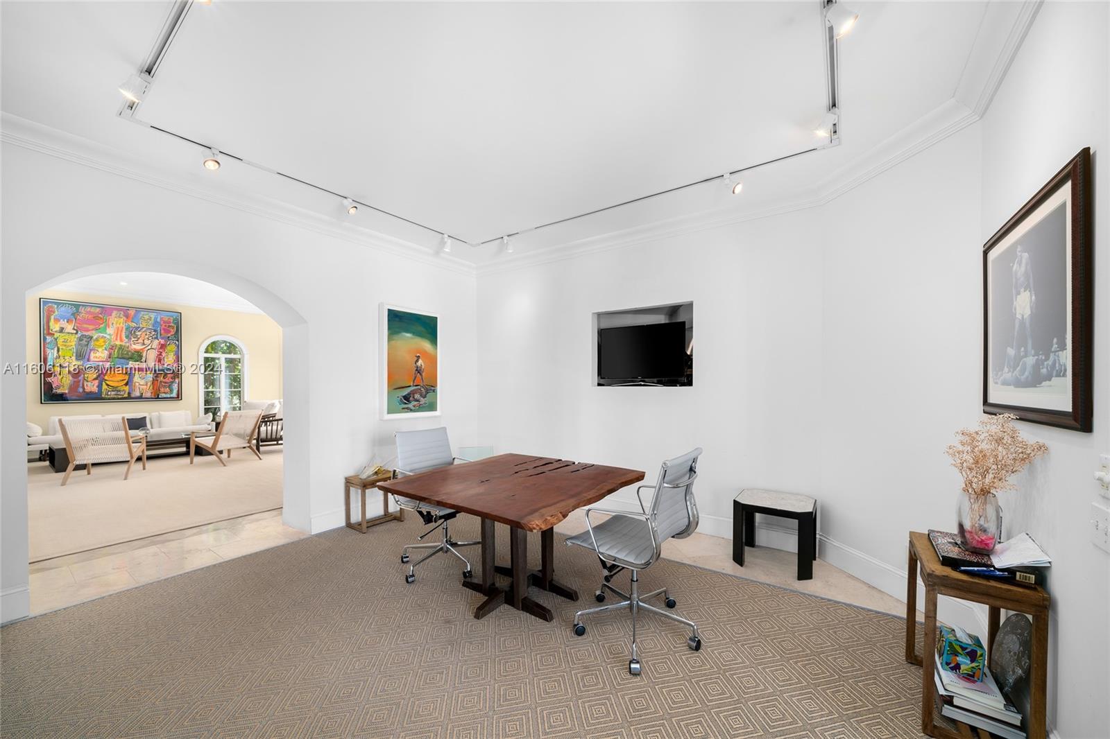 4810 North Bay Road Miami Beach, FL 33140 - Photo 21 of 61 a living room with furniture and a flat screen tv