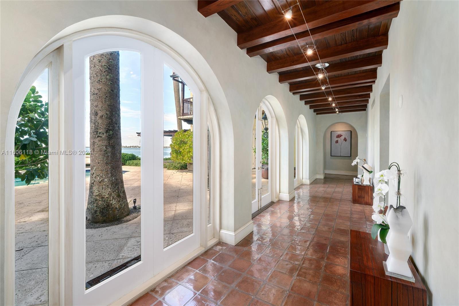 4810 North Bay Road Miami Beach, FL 33140 - Photo 22 of 61 a front view of a house with a glass door and glass door