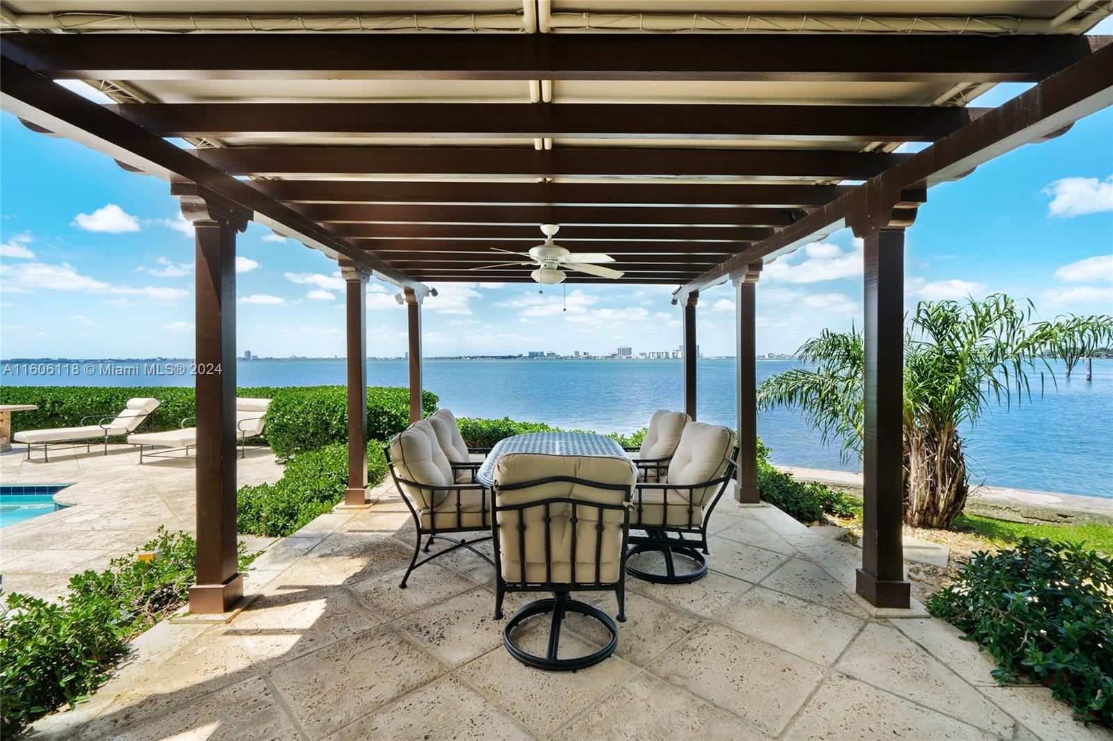 4810 North Bay Road Miami Beach, FL 33140 - Photo 29 of 61 a roof deck with table and chairs and potted plants