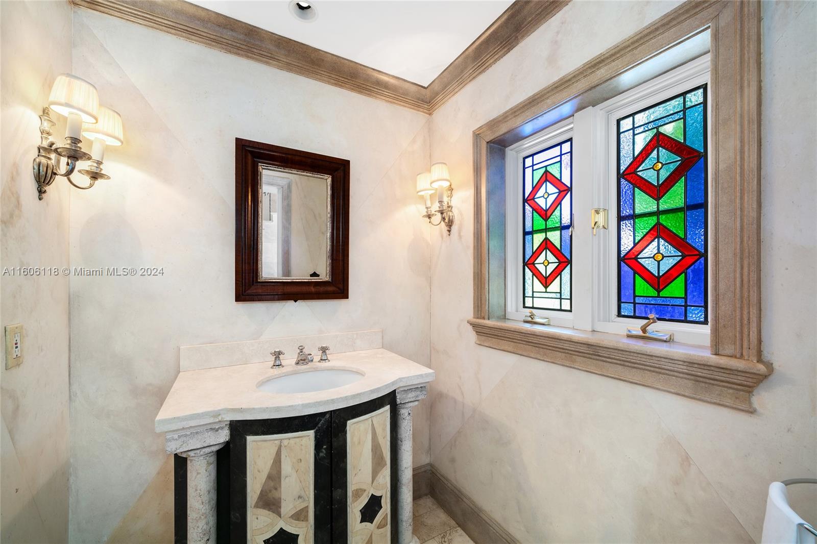 4810 North Bay Road Miami Beach, FL 33140 - Photo 35 of 61 a bathroom with a sink and a mirror