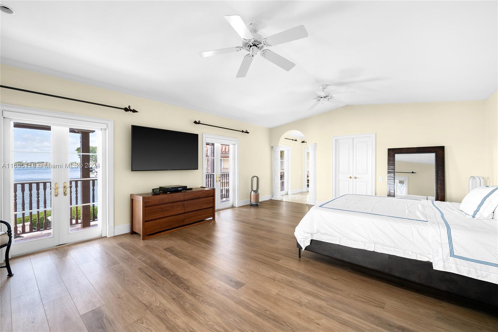 4810 North Bay Road Miami Beach, FL 33140 - Photo 41 of 61 a spacious bedroom with a bed and a flat screen tv