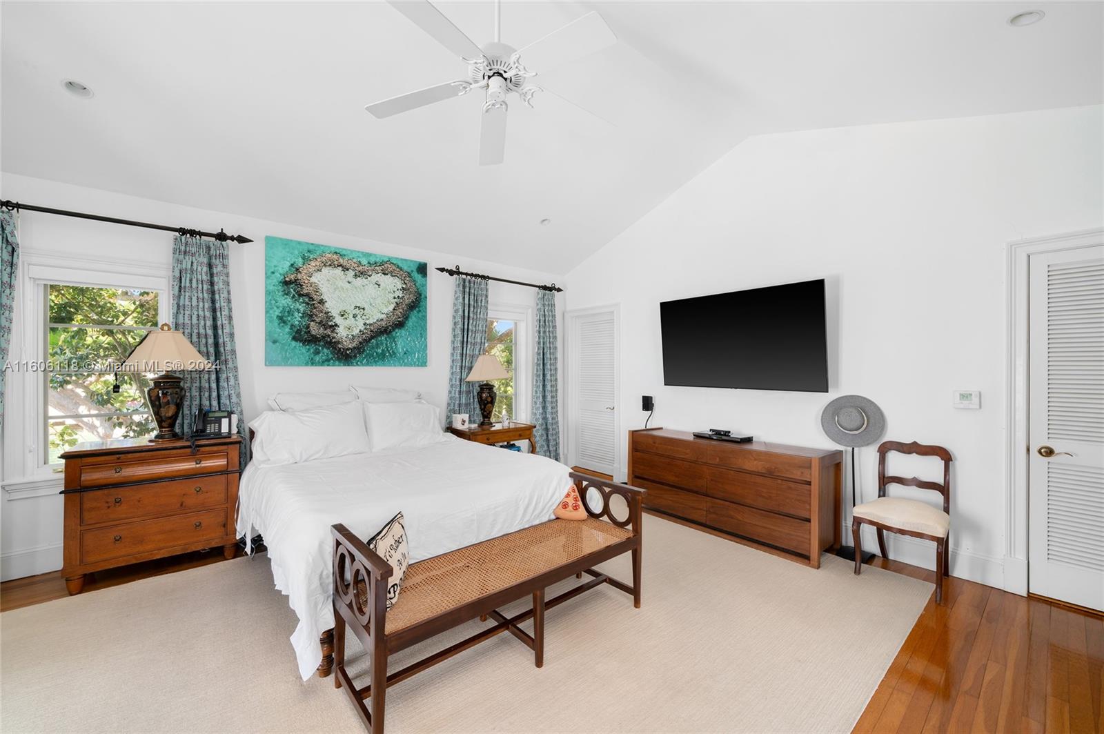 4810 North Bay Road Miami Beach, FL 33140 - Photo 43 of 61 a bedroom with a bed and a flat tv screen on dresser