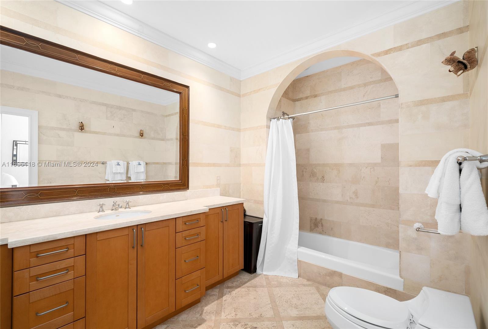 4810 North Bay Road Miami Beach, FL 33140 - Photo 44 of 61 a bathroom with a sink a toilet and shower