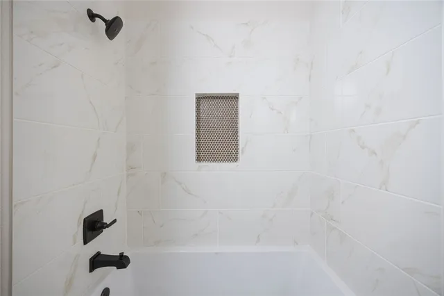 a view of room with ceiling fan and window