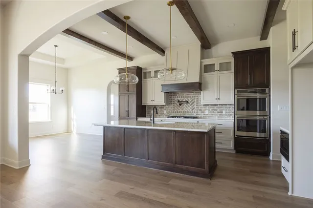 a kitchen with stainless steel appliances a sink stove and refrigerator