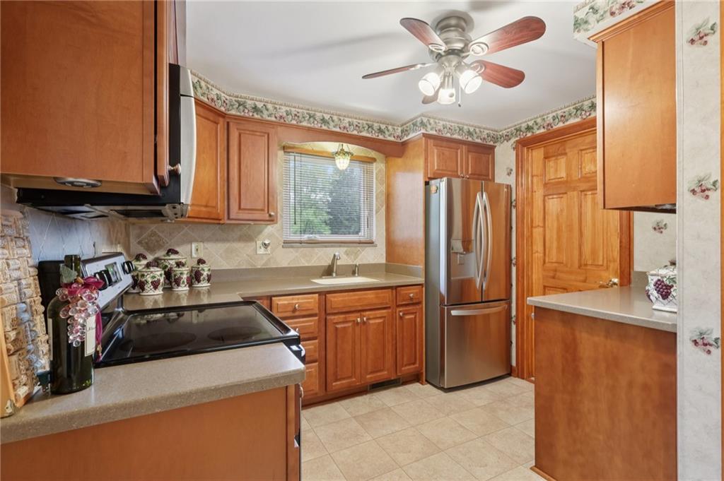 158 Maple Street Rochester, PA 15074 - Photo 13 of 37 a kitchen with a sink a stove and cabinets