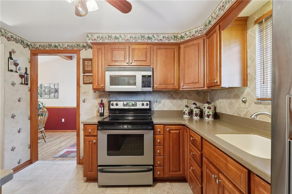 158 Maple Street Rochester, PA 15074 - Photo 14 of 37 a kitchen with stainless steel appliances a stove a sink and a microwave