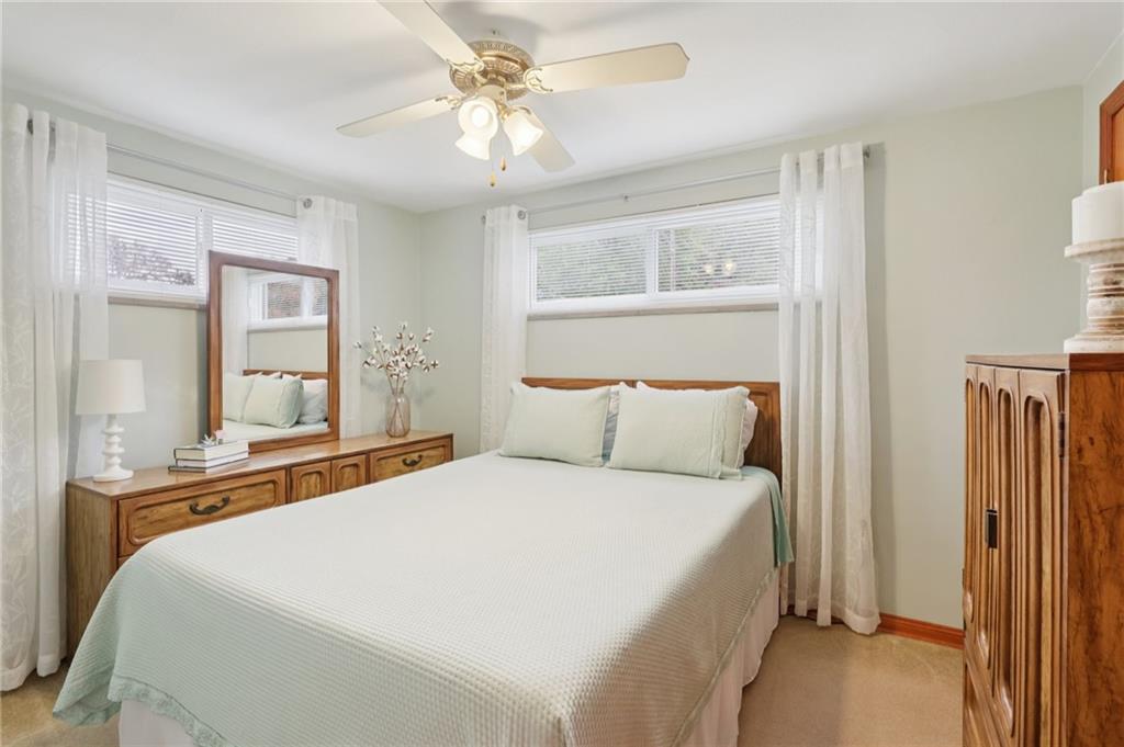 158 Maple Street Rochester, PA 15074 - Photo 18 of 37 a bedroom with a large bed and a chandelier