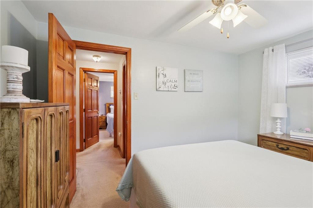 158 Maple Street Rochester, PA 15074 - Photo 19 of 37 a bedroom with a bed and a chandelier