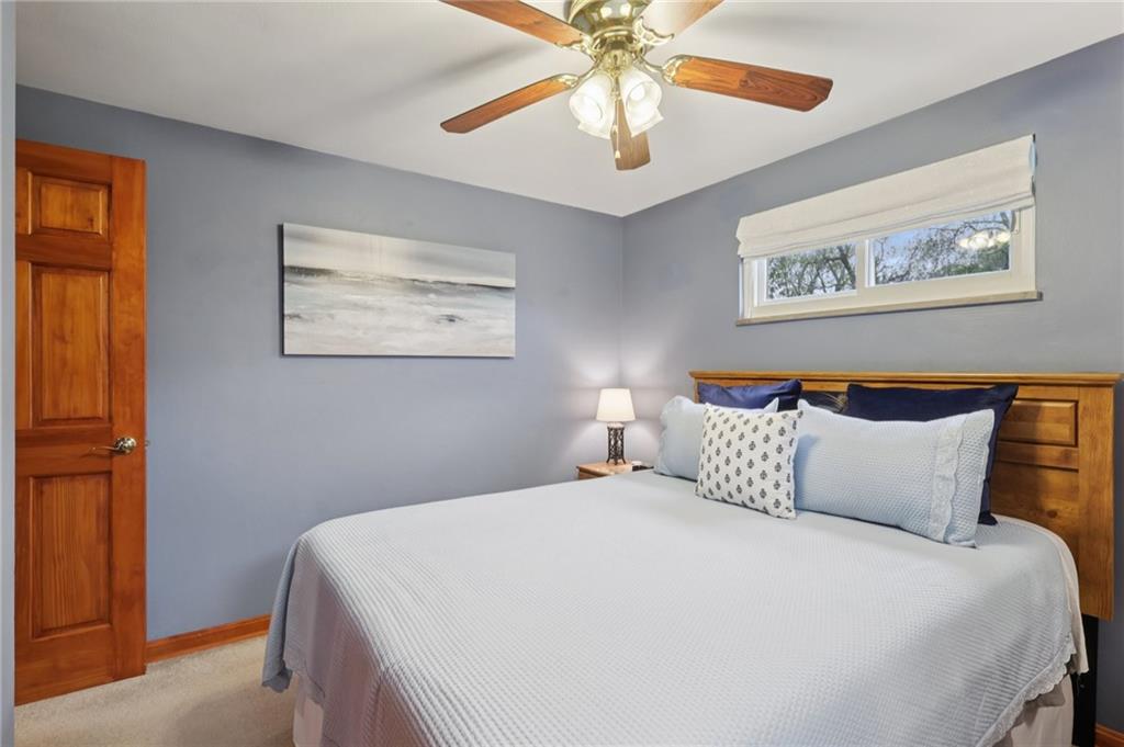 158 Maple Street Rochester, PA 15074 - Photo 25 of 37 a bedroom with a large bed and a chandelier