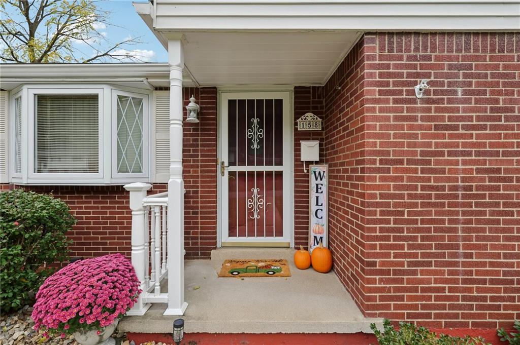 158 Maple Street Rochester, PA 15074 - Photo 6 of 37 a view of brick house with potted plants