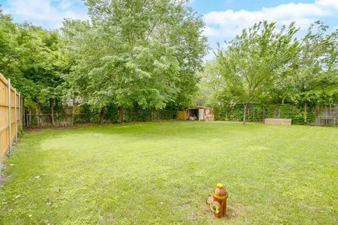 a view of a house with a backyard