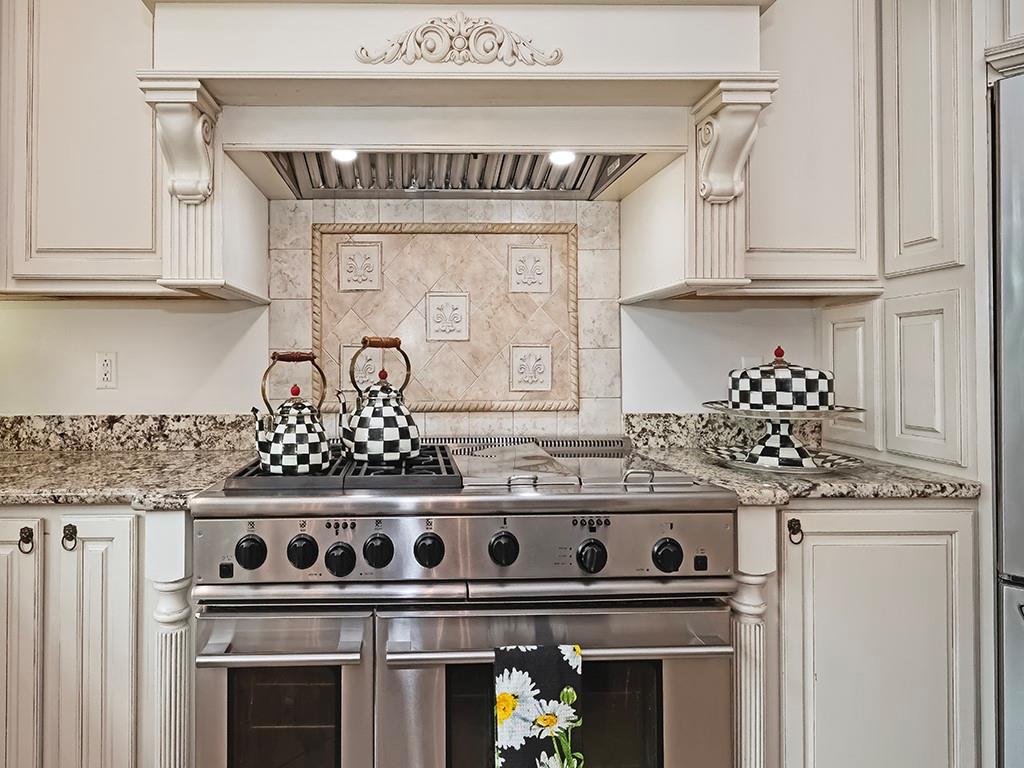 7002 Eagle Road Gibsonia, PA 15044 - Photo 15 of 49 a kitchen with granite countertop a stove and a white cabinet