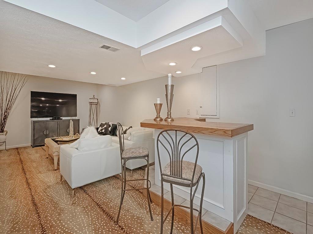 7002 Eagle Road Gibsonia, PA 15044 - Photo 35 of 49 a living room with furniture a flat screen tv and white walls
