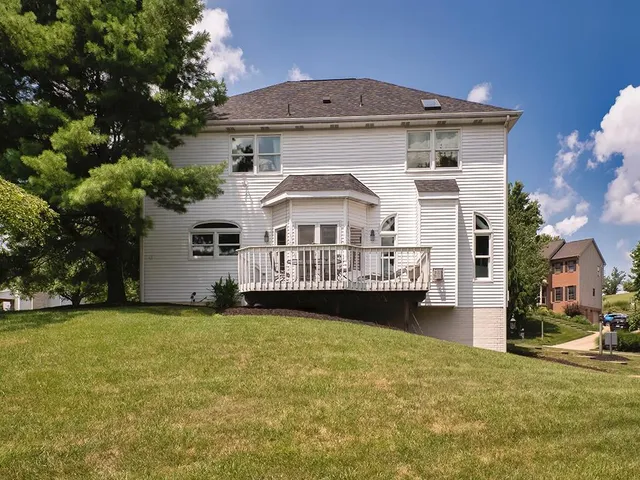 a view of a house with pool and a yard