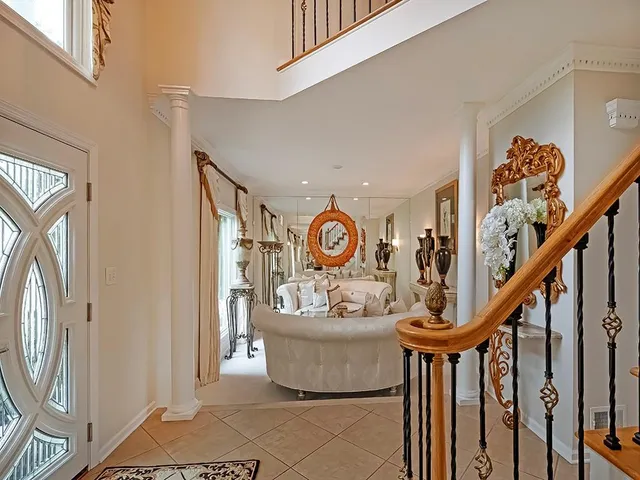 a view of a hallway with entryway wooden floor and furniture