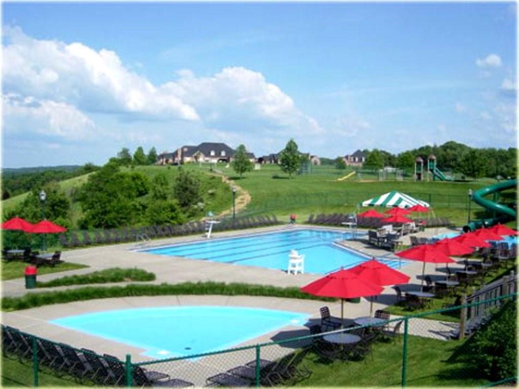 7002 Eagle Road Gibsonia, PA 15044 - Photo 46 of 49 a view of a swimming pool with lawn chairs under an umbrella
