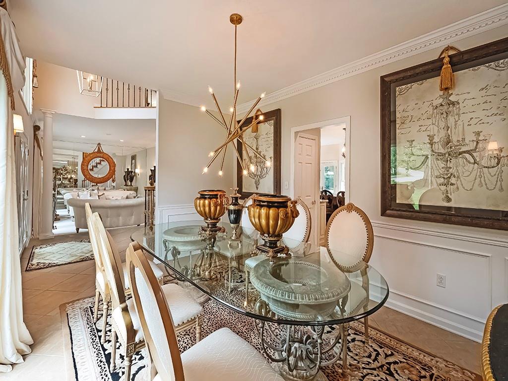 7002 Eagle Road Gibsonia, PA 15044 - Photo 7 of 49 a dining room with wooden floor a chandelier a wooden table and chairs