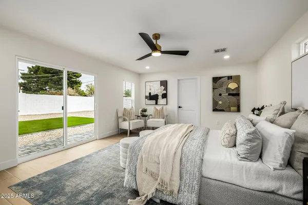 a bed room with a bed and a large window