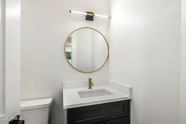 a bathroom with a sink a mirror and a toilet