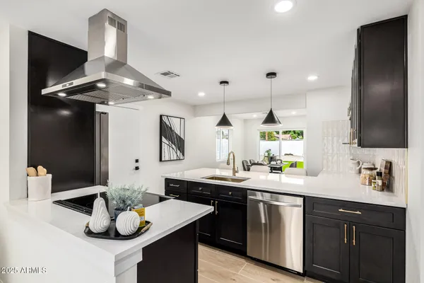 a kitchen with a sink and chandelier