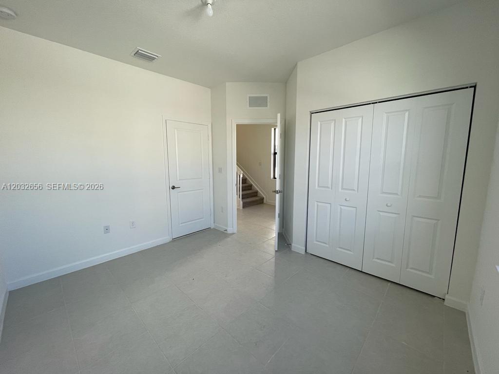 10144 Southwest 228th Terrace Miami, FL 33190 - Photo 20 of 23 an empty room with closet area