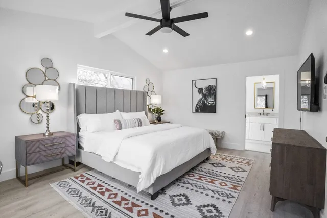 a bedroom with a bed and a flat screen tv