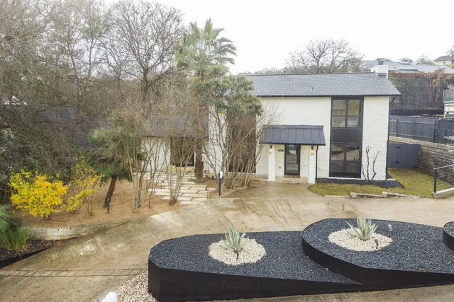 a view of a house with a fountain and a fire pit