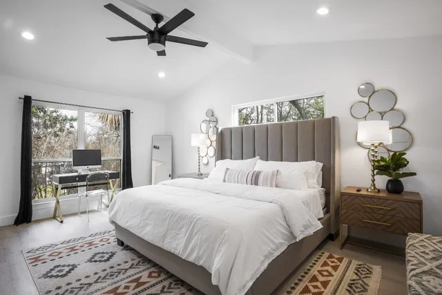 a bedroom with a large bed and a flat screen tv