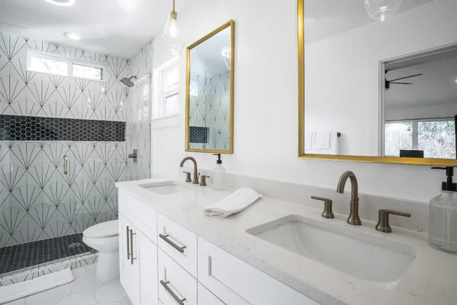 a bathroom with double sink and a mirror