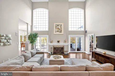 a kitchen with stainless steel appliances granite countertop a sink a stove and a wooden floor