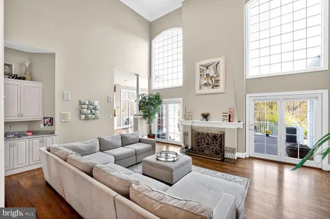 a kitchen with stainless steel appliances granite countertop sink stove and wooden floor