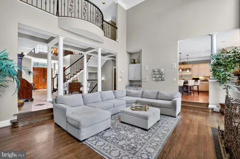 a dining room with furniture wooden floor and a chandelier