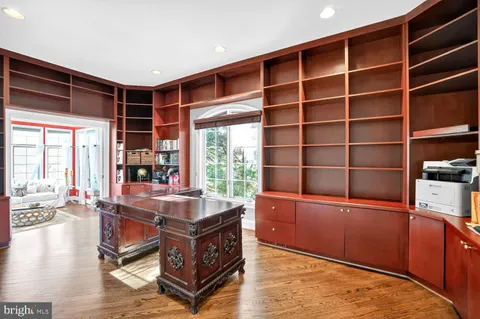a bathroom with a tub a sink and window