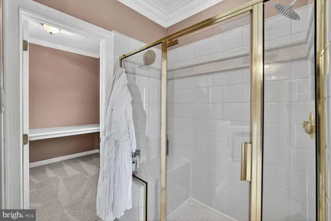 a view of a livingroom with wooden floor and an empty room