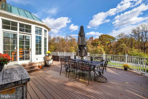 a living room with furniture fireplace and a large window