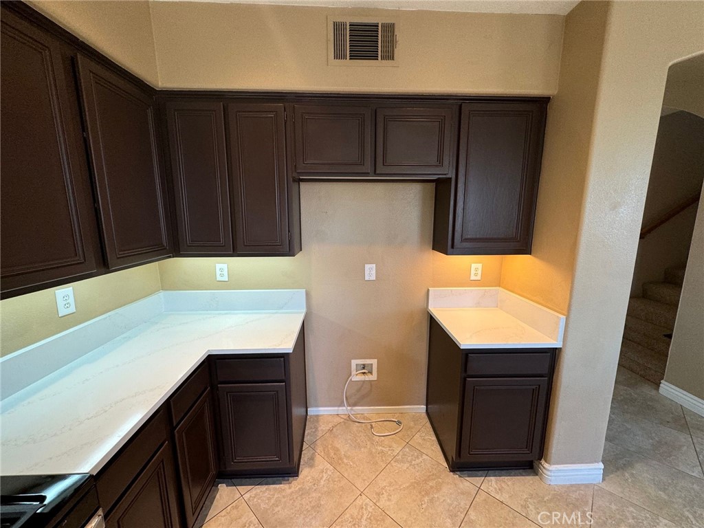 31970 Cercle Chambertin Temecula, CA 92591 - Photo 12 of 45 a kitchen with stainless steel appliances a refrigerator and cabinets