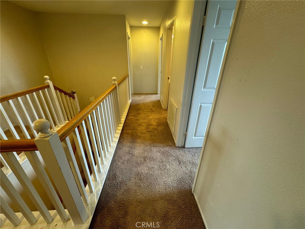 31970 Cercle Chambertin Temecula, CA 92591 - Photo 19 of 45 a view of a hallway with wooden floor