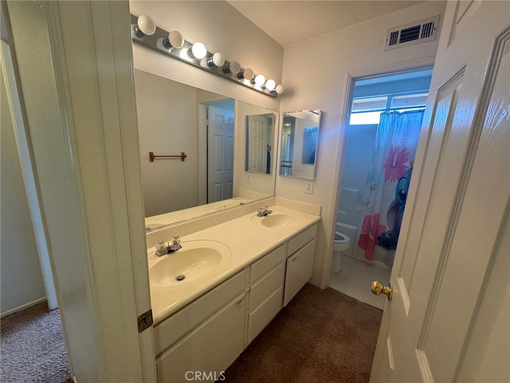 31970 Cercle Chambertin Temecula, CA 92591 - Photo 25 of 45 a bathroom with a double vanity sink and a mirror