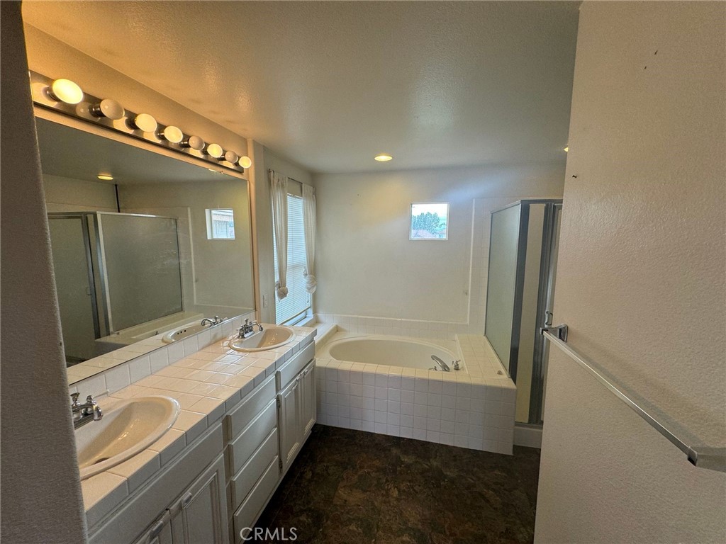 31970 Cercle Chambertin Temecula, CA 92591 - Photo 34 of 45 a bathroom with a tub sink and mirror