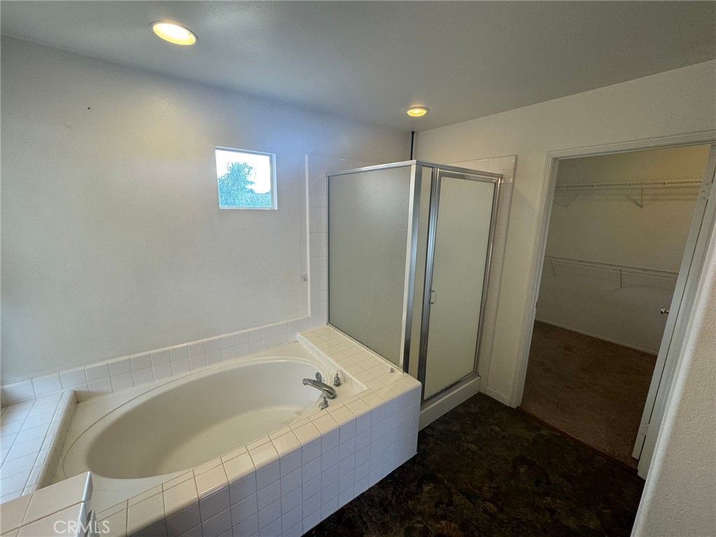 31970 Cercle Chambertin Temecula, CA 92591 - Photo 35 of 45 a bathroom with a bathtub and a shower