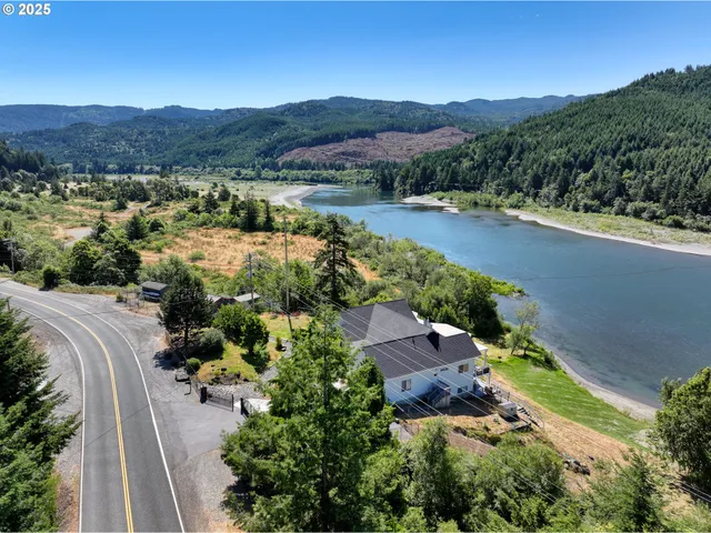 an aerial view of green landscape with trees houses and mountain view