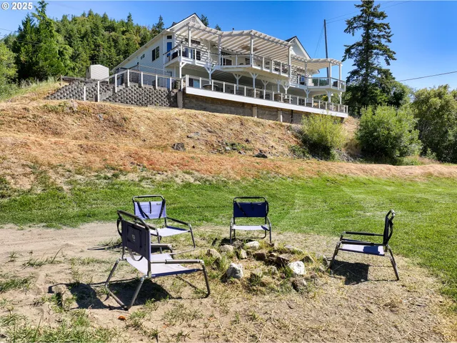 a view of a chairs and table in patio with a lake view