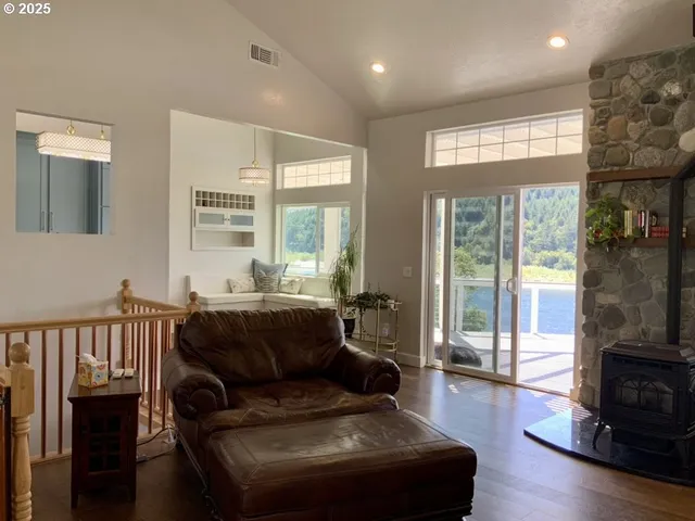 a living room with furniture a flat screen tv and a large window